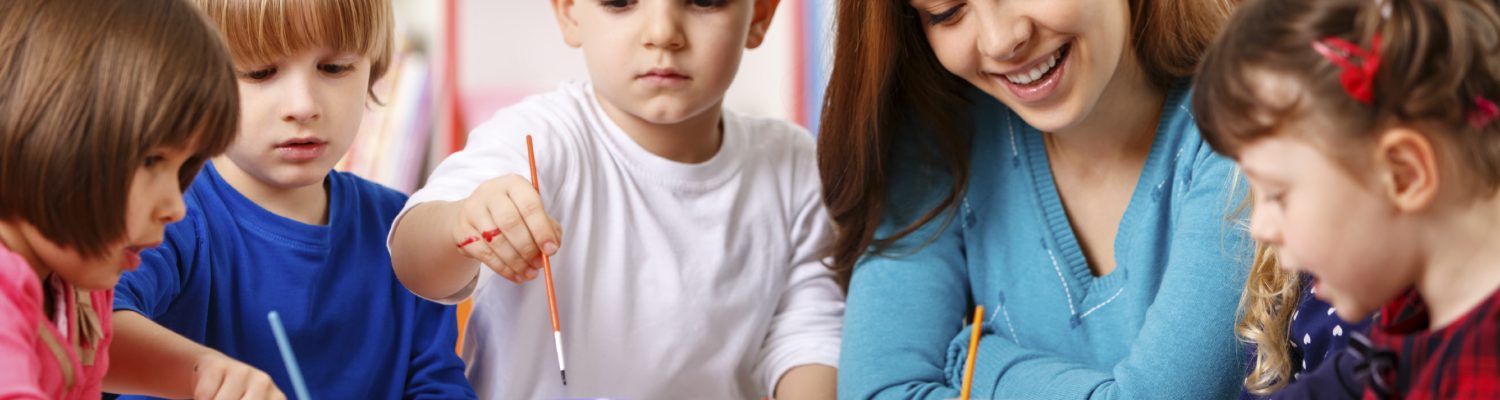 Group Of Elementary Age Children In Art Class With Teacher